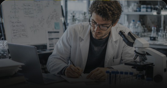 Researcher taking notes with a laptop
